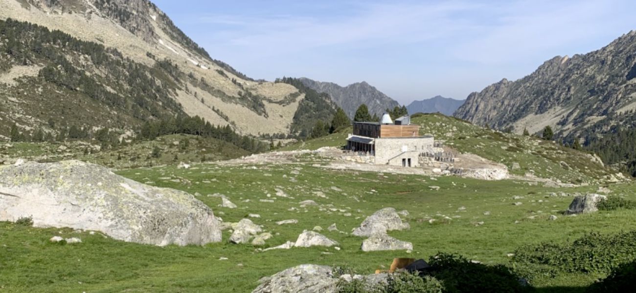 Le refuge d'Aygues-Cluses dans son paysage de montagnes. Construction de l'Atelier Ott, architecte : Nathalie Ott